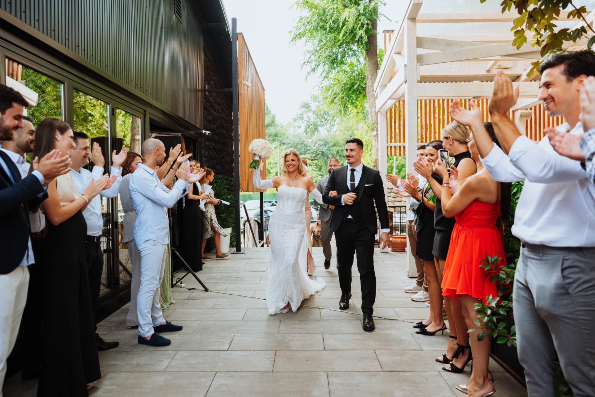 Bride and groom celebrating with wedding guests at Restaurant Suvenir in Novi Sad, Serbia – Nemanja Potkonjak Wedding Photography